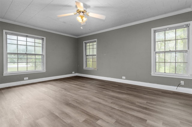 spare room with hardwood / wood-style floors, crown molding, and ceiling fan