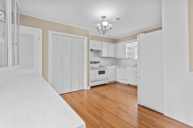 kitchen with white cabinetry, light hardwood / wood-style flooring, a notable chandelier, white appliances, and crown molding