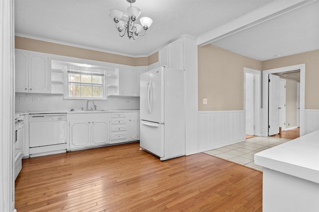 kitchen with white cabinetry, white appliances, sink, and light hardwood / wood-style flooring