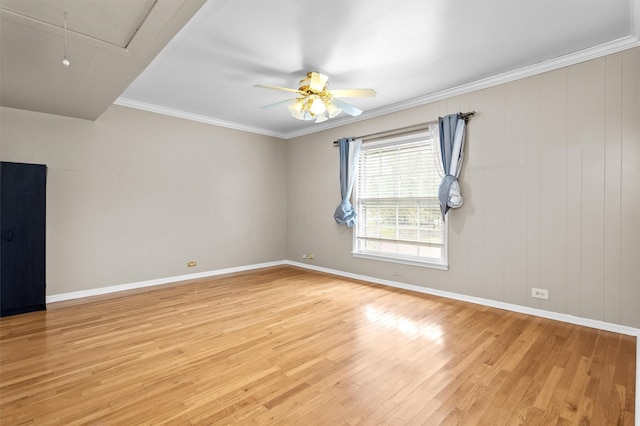 empty room featuring light wood-type flooring, ceiling fan, and crown molding