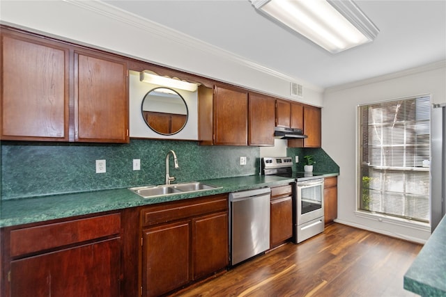 kitchen with appliances with stainless steel finishes, sink, crown molding, dark hardwood / wood-style flooring, and tasteful backsplash