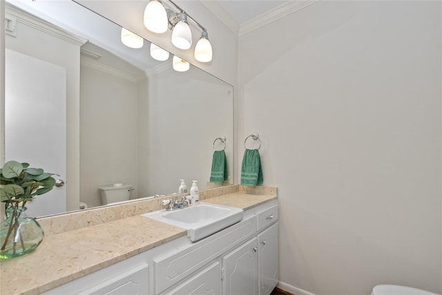 bathroom with toilet, crown molding, and vanity