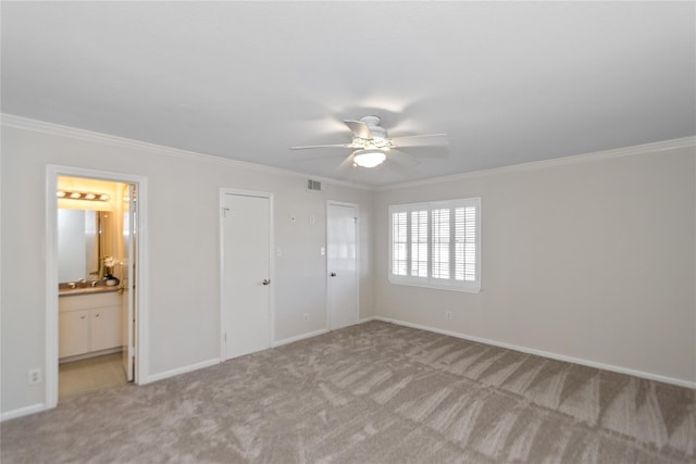 unfurnished bedroom with light carpet, ensuite bathroom, and crown molding