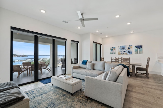 living area with recessed lighting, visible vents, and wood finished floors