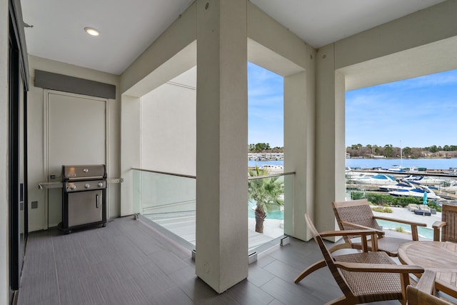 balcony featuring a water view and grilling area