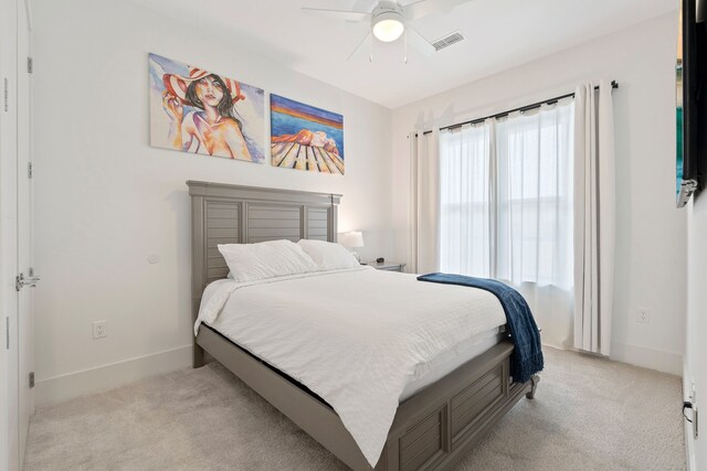 bedroom with light colored carpet, visible vents, and baseboards