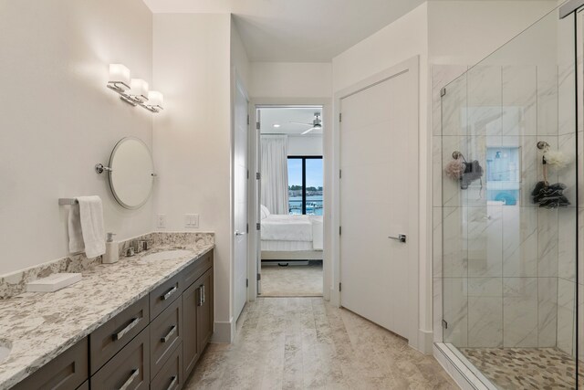 full bathroom featuring a stall shower, vanity, and ensuite bath