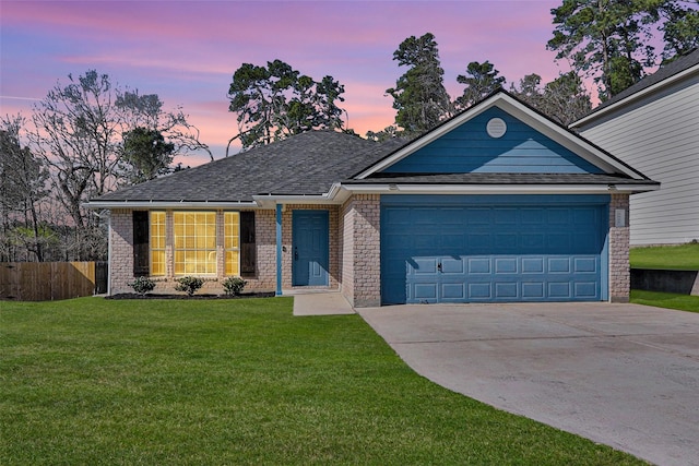 view of front facade featuring a garage and a yard