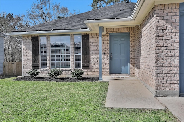 doorway to property with a yard