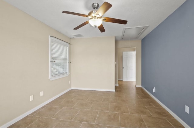 tiled spare room featuring ceiling fan