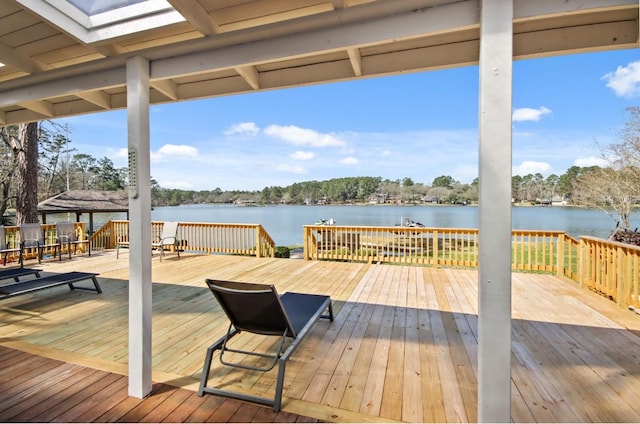 wooden terrace featuring a water view