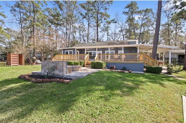 rear view of house featuring a yard and a wooden deck