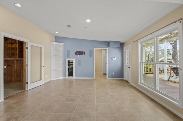 unfurnished room with light tile patterned floors