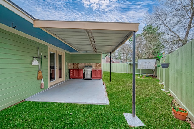 view of yard with exterior kitchen, a patio area, and a fenced backyard