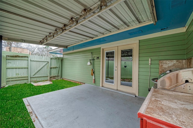 view of patio / terrace with a gate, fence, and french doors