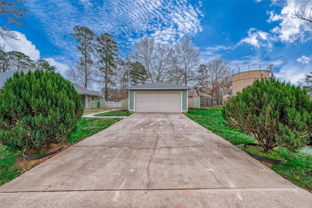 exterior space with a garage and a front lawn