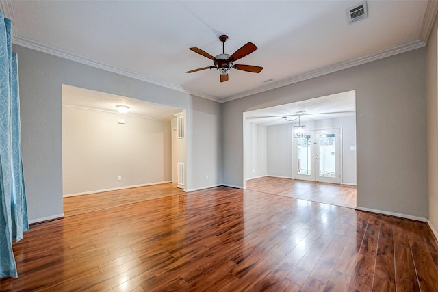 unfurnished room featuring ceiling fan, visible vents, ornamental molding, and wood finished floors