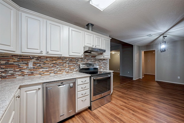 kitchen featuring stainless steel appliances, white cabinets, under cabinet range hood, and light wood finished floors