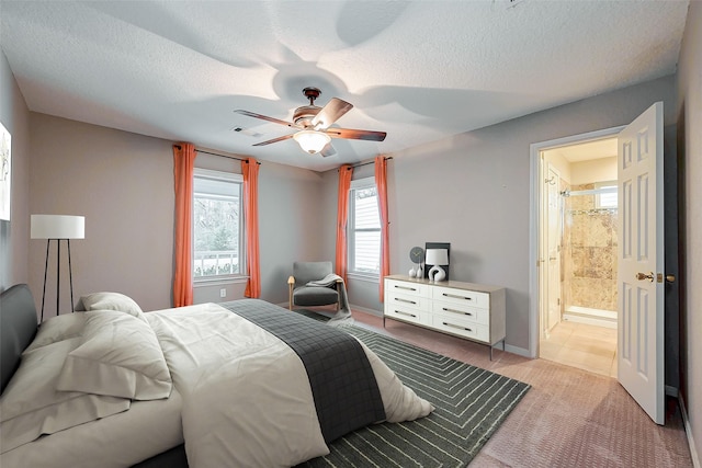 bedroom featuring a textured ceiling, ceiling fan, light carpet, visible vents, and baseboards