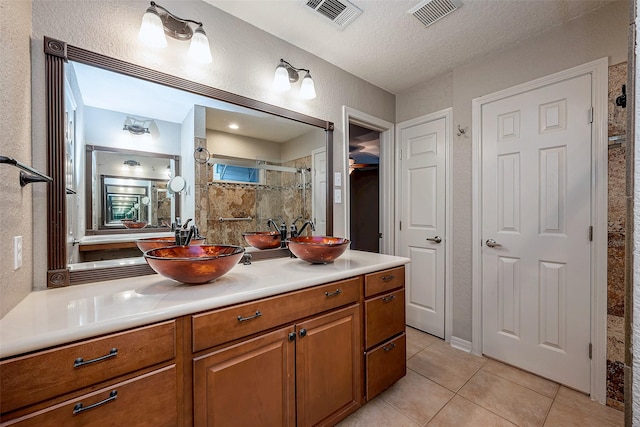 full bathroom with visible vents, a sink, and tile patterned floors