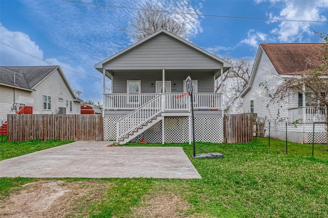 view of front of property with covered porch and a front lawn