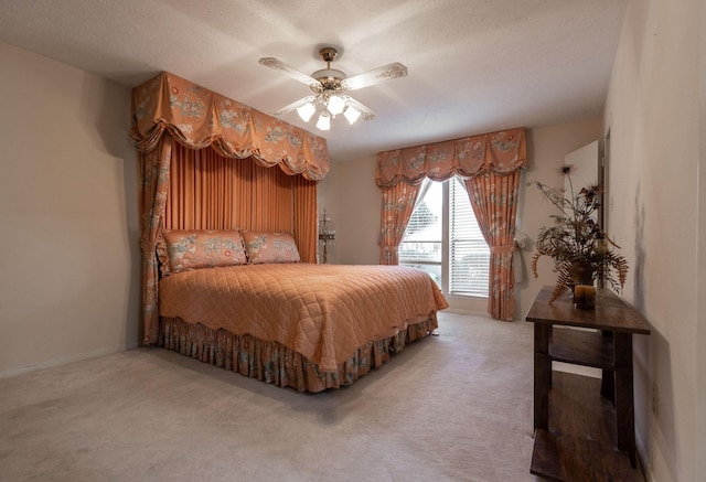 bedroom with a ceiling fan and carpet