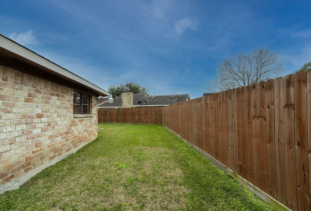 view of yard featuring a fenced backyard