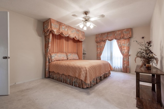 carpeted bedroom featuring a textured ceiling and a ceiling fan