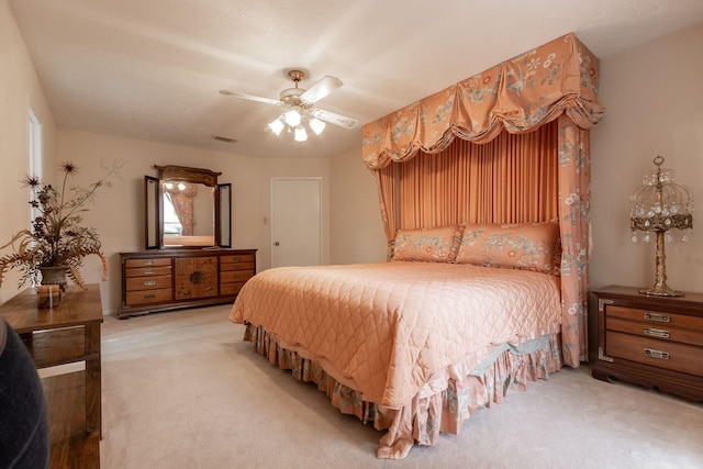 bedroom with carpet, visible vents, and a ceiling fan