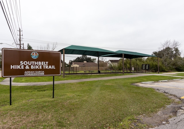 surrounding community featuring a carport and a lawn