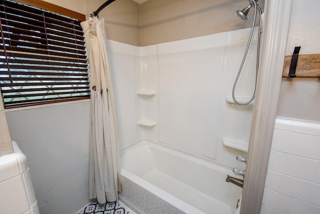 bathroom featuring tile walls and shower / bath combination with curtain