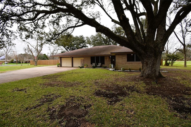 view of front of home with a front yard and a garage