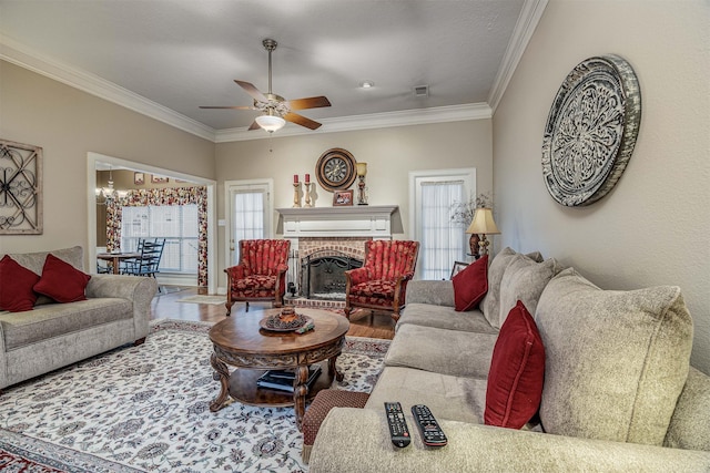 living room with ornamental molding, visible vents, and plenty of natural light