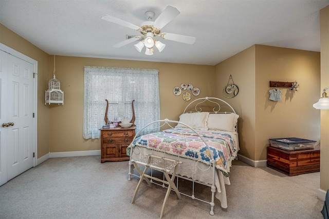 bedroom featuring carpet floors, a ceiling fan, and baseboards