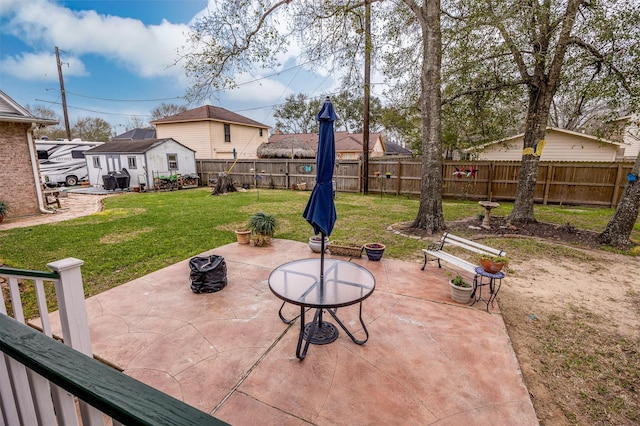 view of patio featuring a fenced backyard and an outbuilding