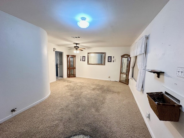 unfurnished living room with light carpet and ceiling fan