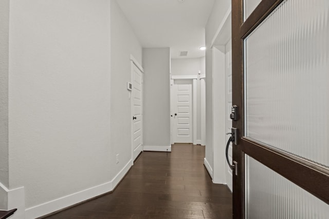 corridor featuring dark wood-type flooring