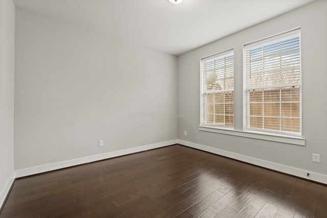 unfurnished room with dark hardwood / wood-style floors