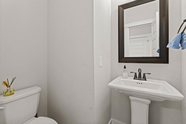 bathroom featuring sink and toilet