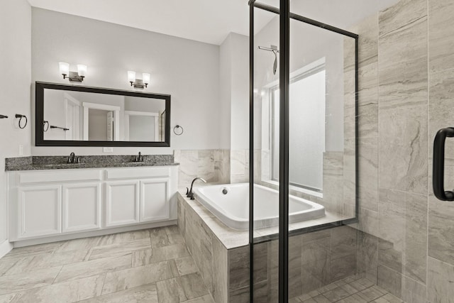 bathroom featuring vanity and independent shower and bath