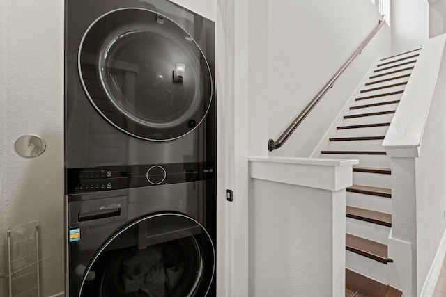 laundry room with stacked washer / drying machine