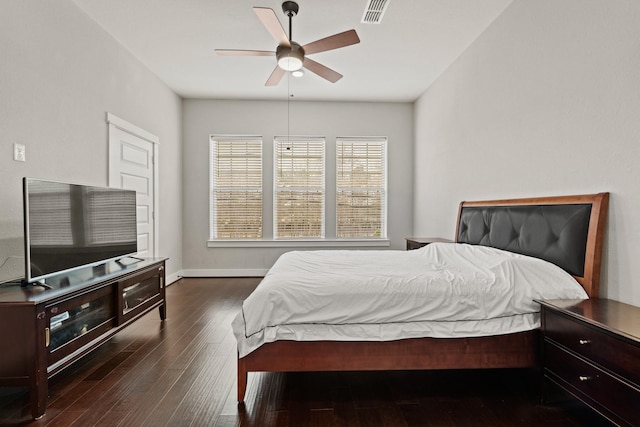 bedroom with ceiling fan and dark hardwood / wood-style flooring