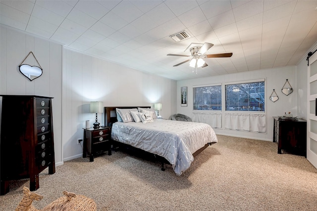 carpeted bedroom with visible vents and ceiling fan