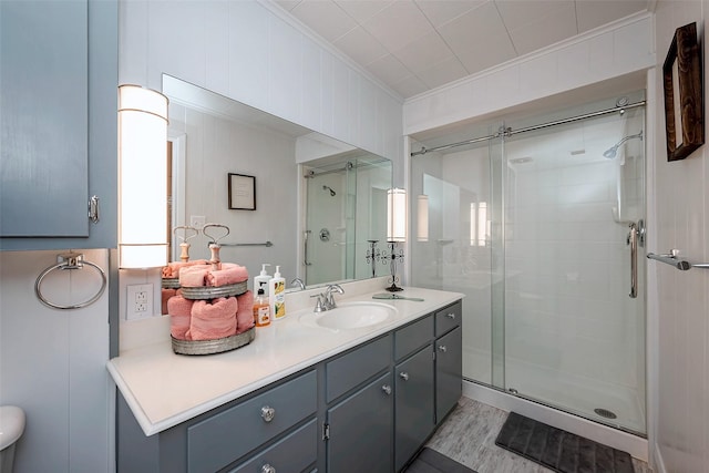 full bath featuring ornamental molding, a stall shower, and vanity
