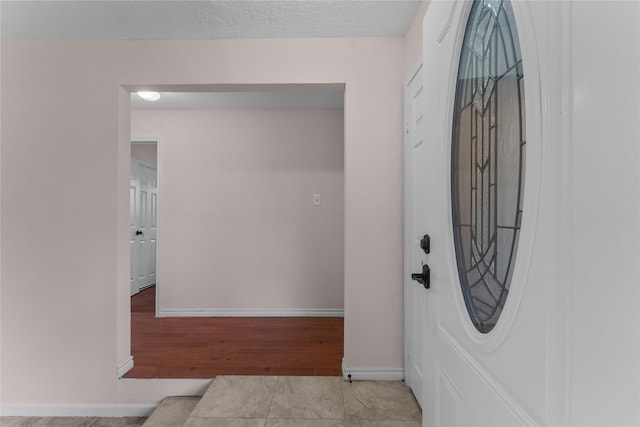 interior space featuring light hardwood / wood-style floors and a textured ceiling