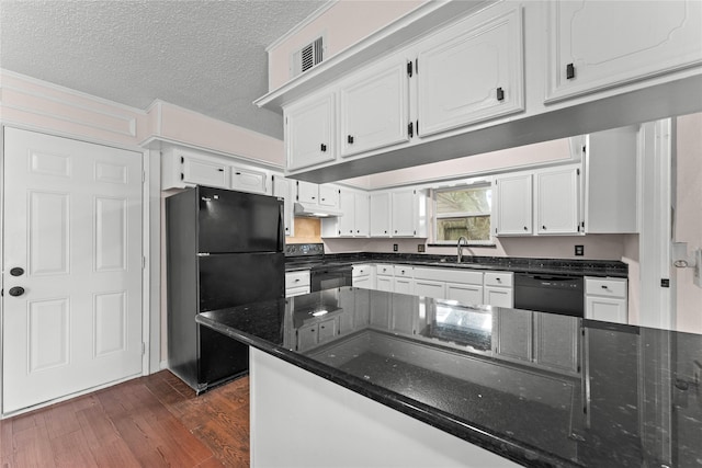 kitchen with a textured ceiling, black appliances, dark hardwood / wood-style flooring, sink, and white cabinetry