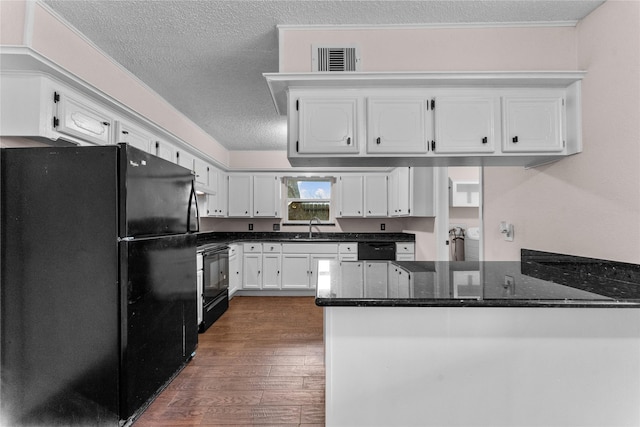 kitchen featuring white cabinets, dark stone counters, black appliances, and kitchen peninsula