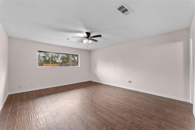 unfurnished room with ceiling fan and dark hardwood / wood-style flooring