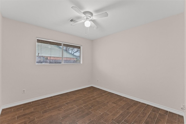 spare room with dark hardwood / wood-style flooring and ceiling fan