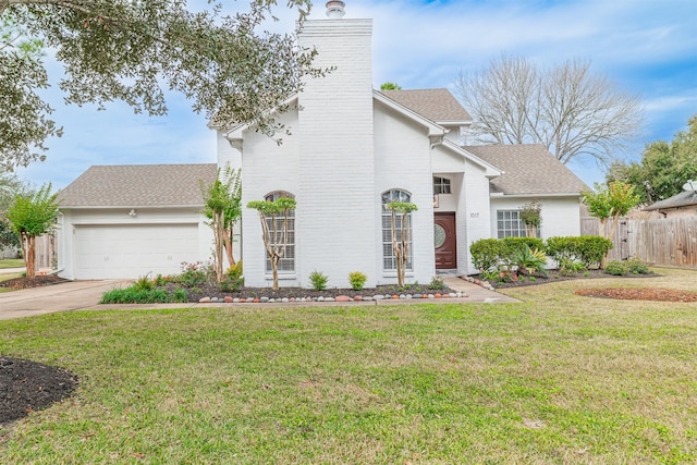 view of front of property with a front yard and a garage